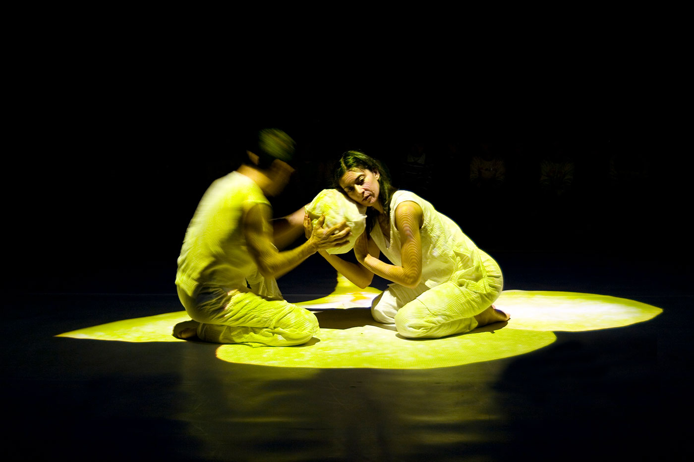 Kaksi tanssijaa pitelee munaa, josta kuoriutuu myöhemmin perhosentoukka.